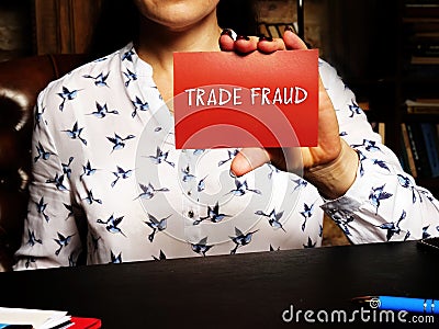 TRADE FRAUD inscription on the piece of paper. the criminal offence of carrying on ofbusiness by a company for aÂ fraudulentÂ  Stock Photo